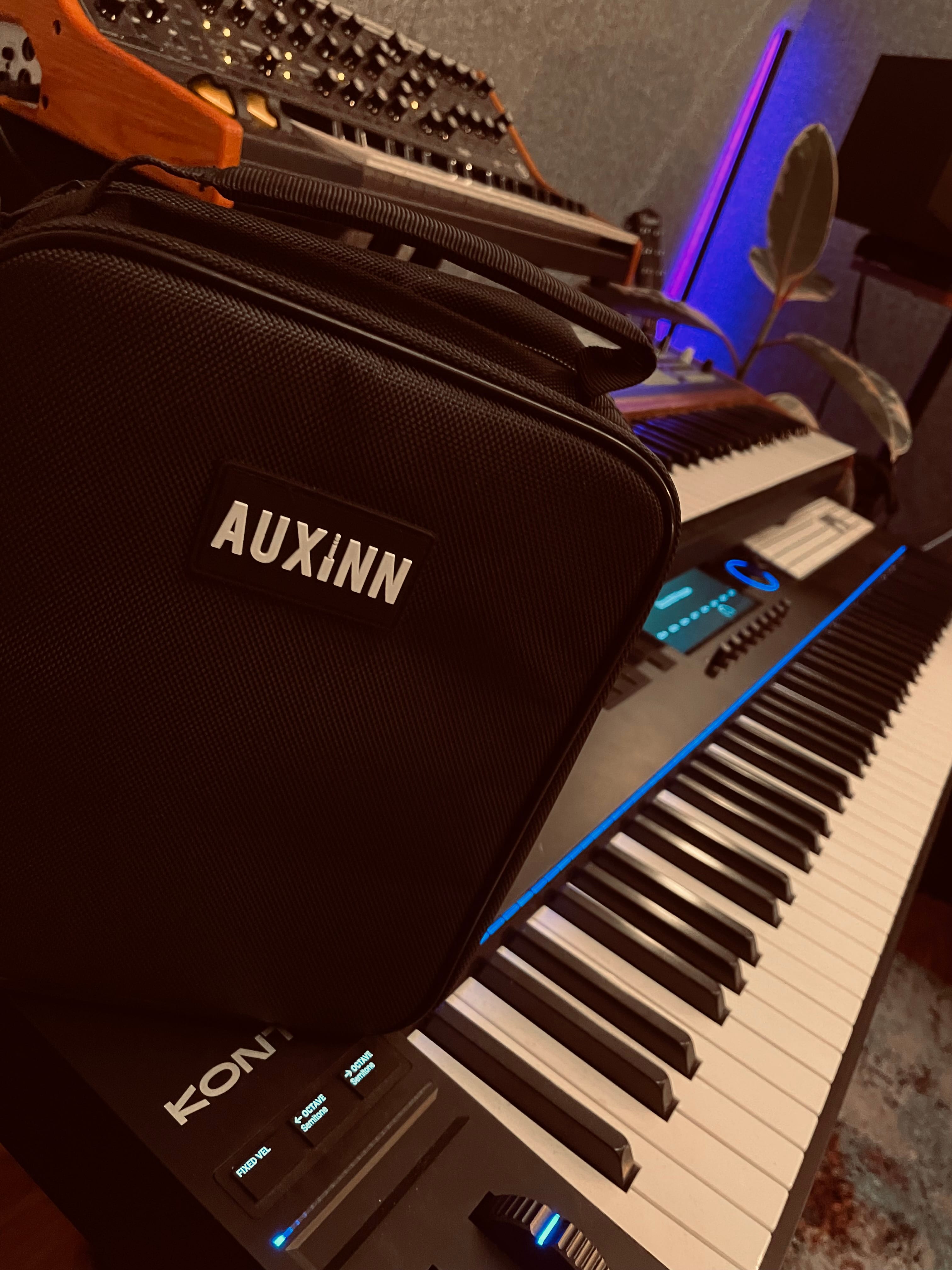 Auxinn bag in context with synths and CDJs